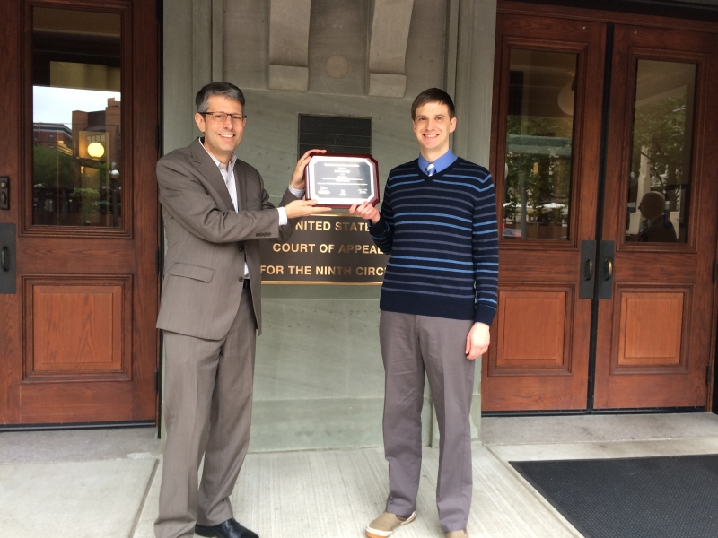 ELR Editor-in-Chief Jay Austin presents Joel Reschly with a plaque for his winning entry.